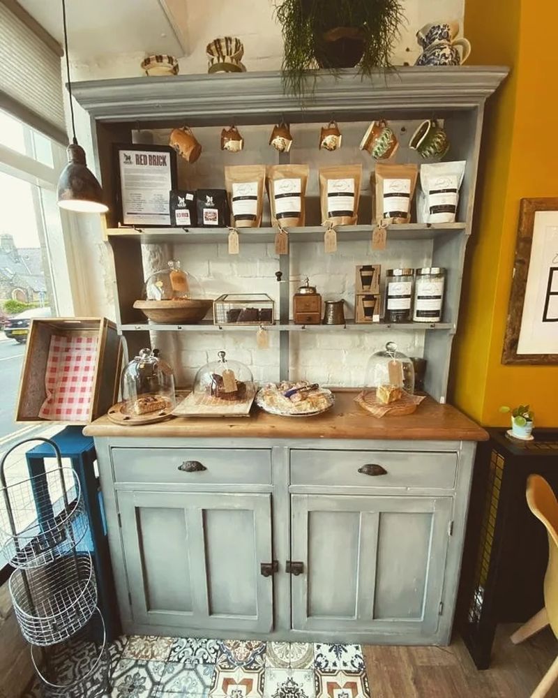 Painted vintage dresser styled with coffee bags and mugs at Daniel's Bistro