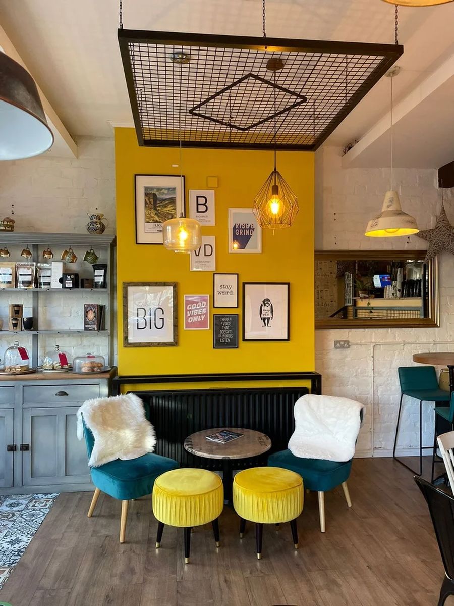 Bright yellow feature wall with teal velvet seating at Daniel's Bistro